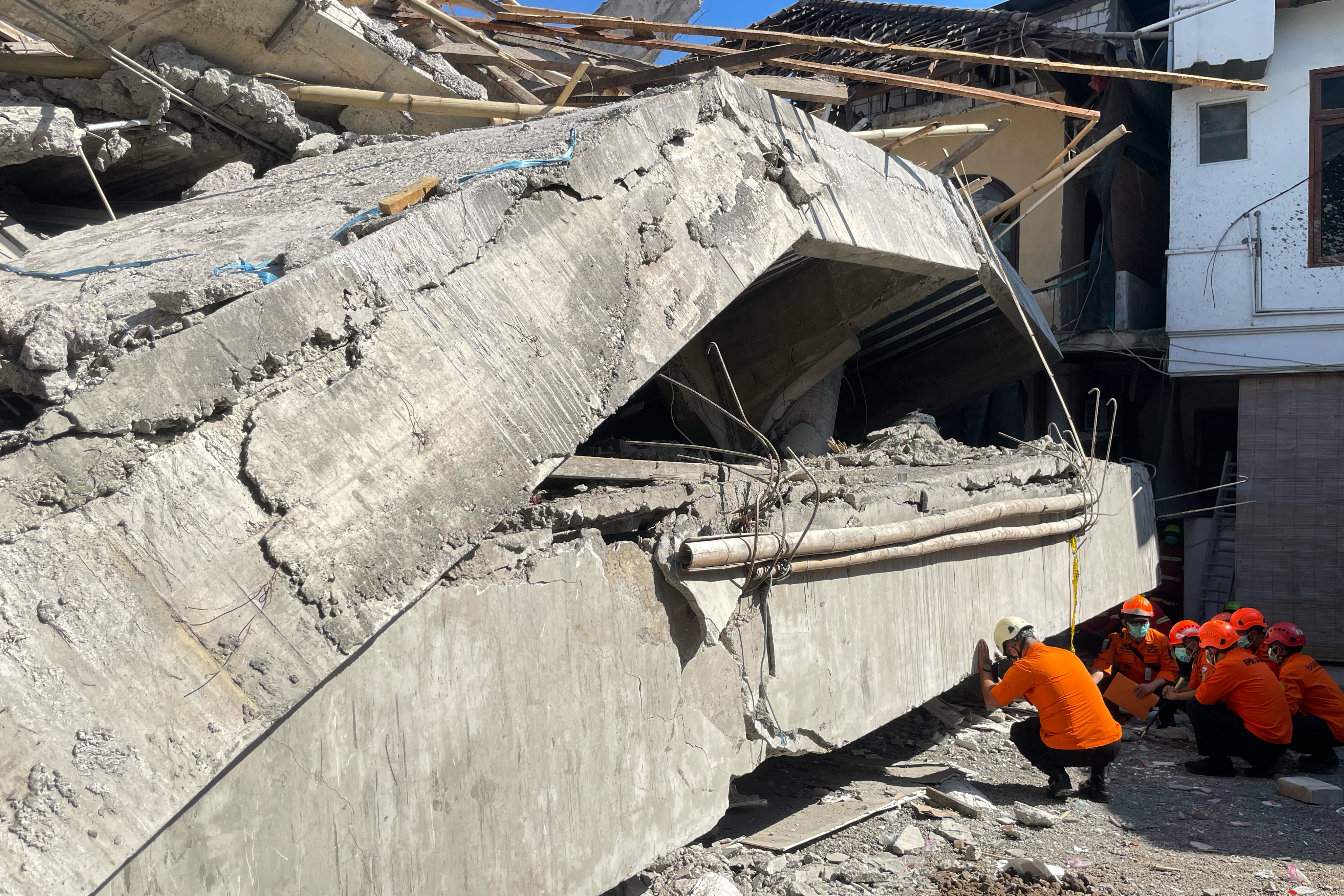Rescuers search for victims after a building under construction collapsed, at an Islamic boarding school in Sidoarjo, East Java, Indonesia, Wednesday, Oct. 1, 2025. (AP)